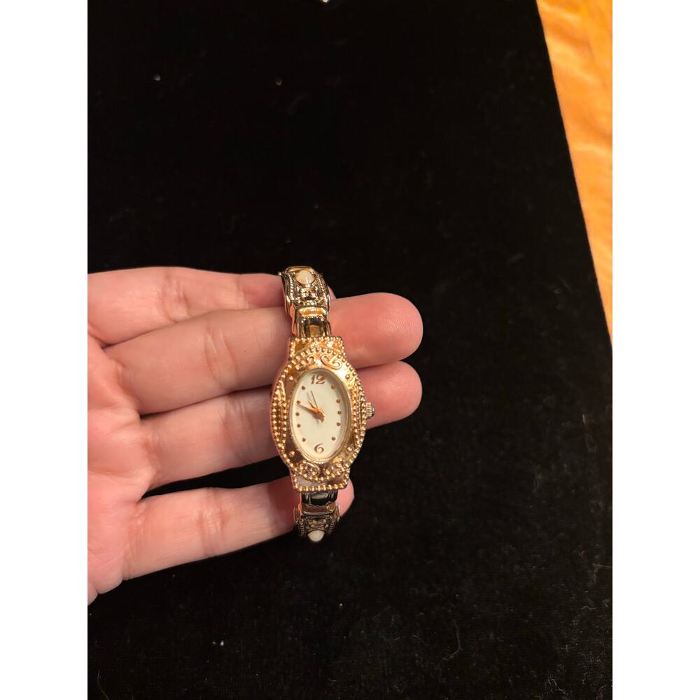 vintage-style gold-tone cuff bracelet watch with oval decorative pearl beads.